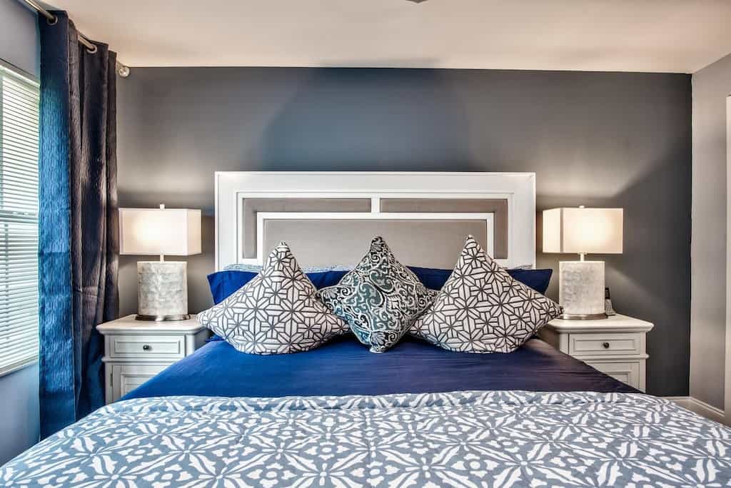 Photo of the luxurious blue and white bedding of the king sized bed in the King Condo. 