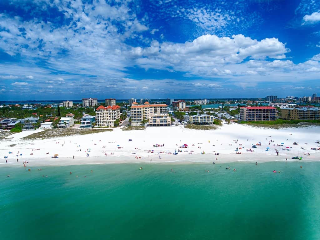 The clear turquoise waters and white sand of Clearwater Beach viewed from above. 