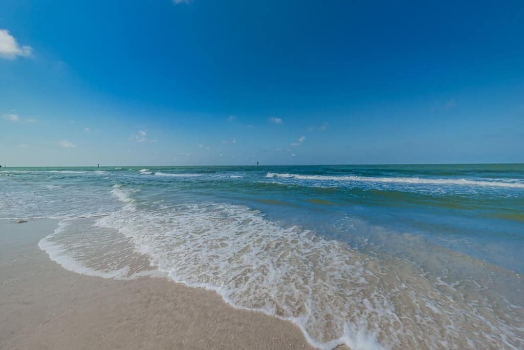 view of the white sandy beaches and blue sky of North Clearwater Beach. 