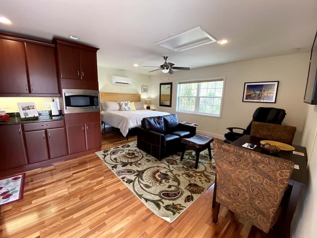 View of the studio setting of the Downtown Carriage House property featuring hardwood floors.