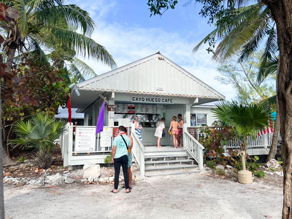 Four people wait for their orders on the porch of Cayo Hueso Cafe, the cafe located at the beach in Fort Zachary Taylor State Park.