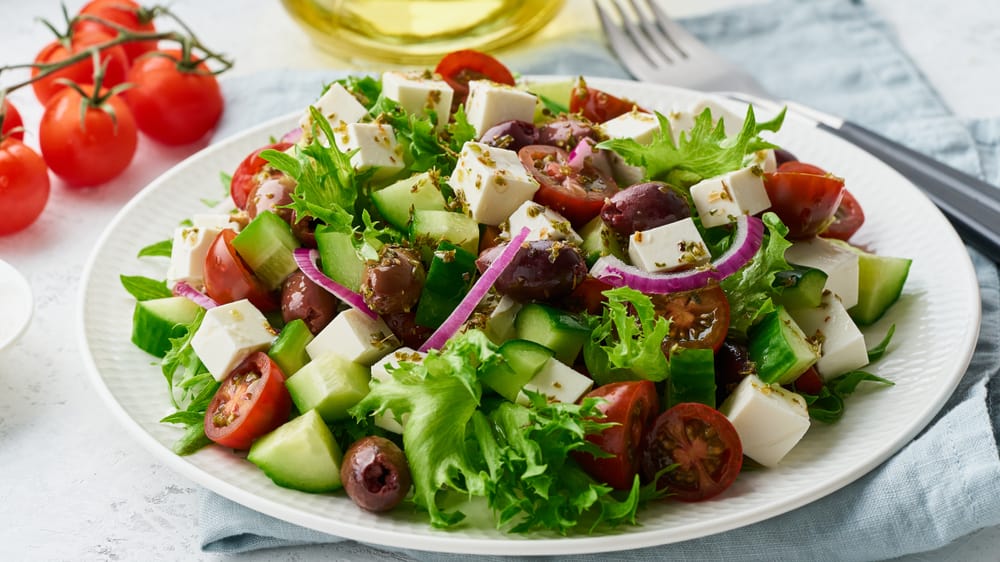 A Mediterranean salad with a mix of vegetables and feta cheese.