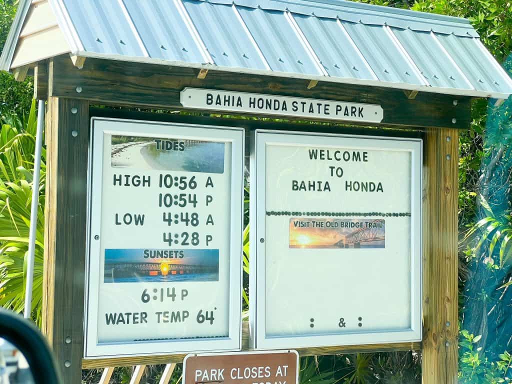 The Bahia Honda State Park advertises all its important information on this sign, such as when the tides are, sunset times, and more.