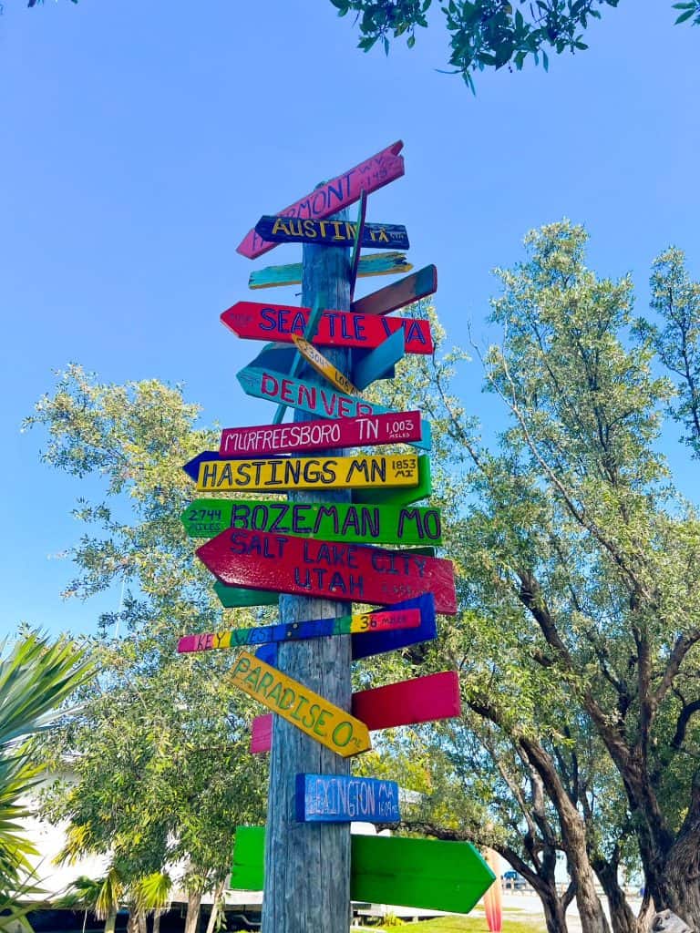 Signs on Bahia Honda State Park ground visitors with mile markers and point to different destinations. 