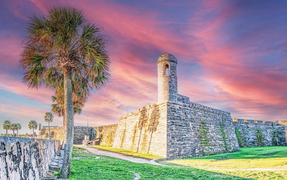 Castillo San Marcos fort at sunset time with palm tree