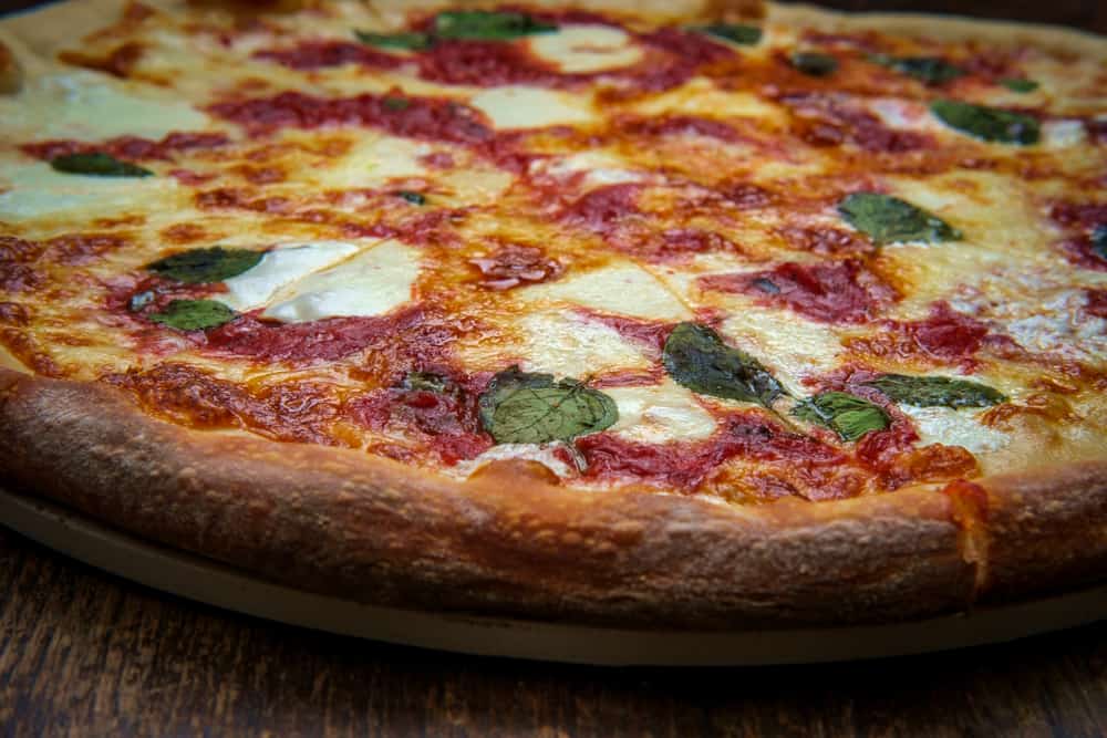 New York style pizza with fresh mozzarella, sauce and fresh basil