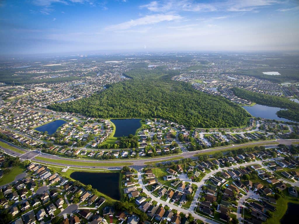 arial view of the town of Kissimmee with lakes and homes and green trees