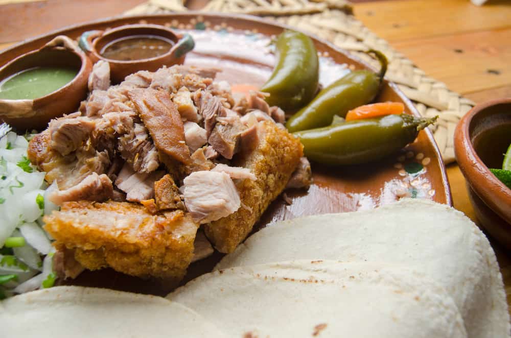 This authentic Mexican restaurant in Kissimmee serves pork with rice and homemade sauces on a plate