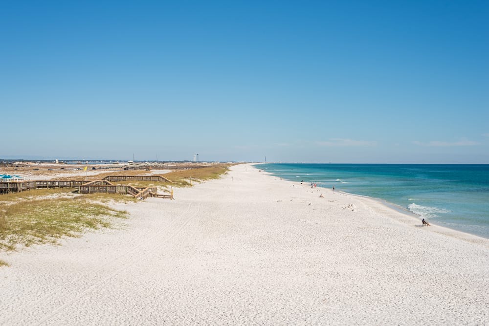 Boardwalks cut across sand dune that lead to the beautiful white sands of Navarre Beach, one of the best Panhandle beaches.