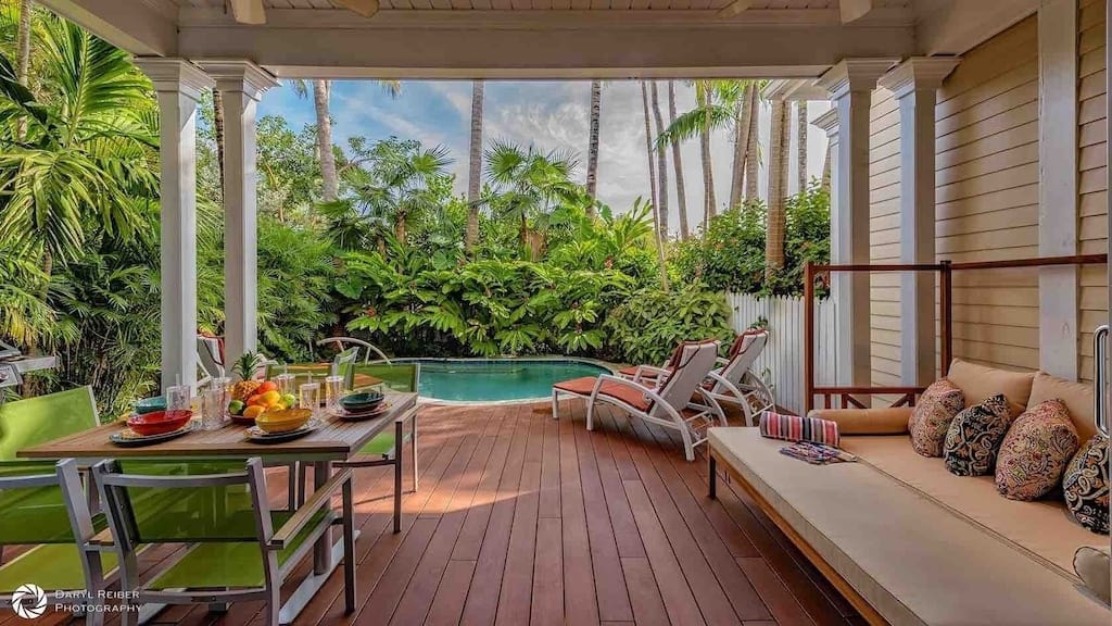 The luxurious back deck (including an outdoor table for 6) lounge chairs, and private pool of the Jasmine Jewel. 