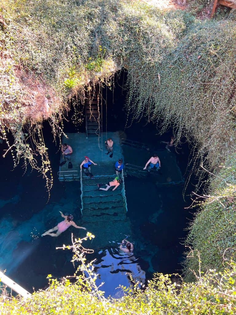 The chimney perspective of Devil's Den shows crowds snorkeling, swimming, and preparing to get into the water. 