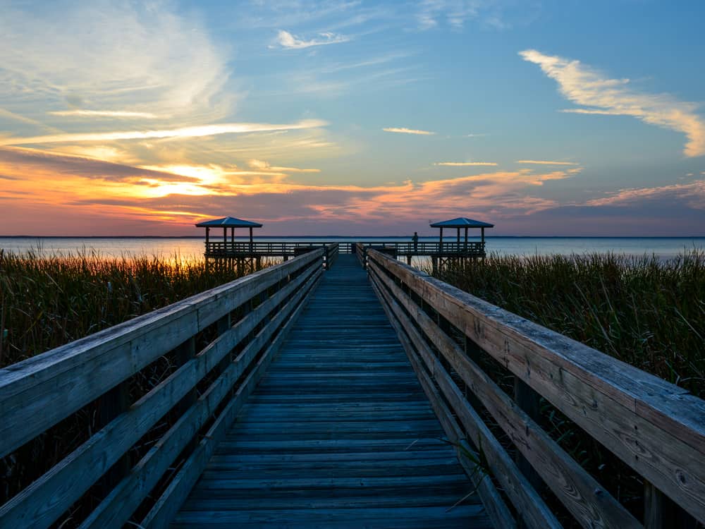 Broadwalk leading towards the lake with two wooden structures at the side. Lake George is one of the lake in Florida 