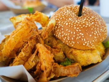 A grouper burger and onion rings sit in a basket at one of the most iconic restaurants in Punta Gorda