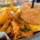 A grouper burger and onion rings sit in a basket at one of the most iconic restaurants in Punta Gorda