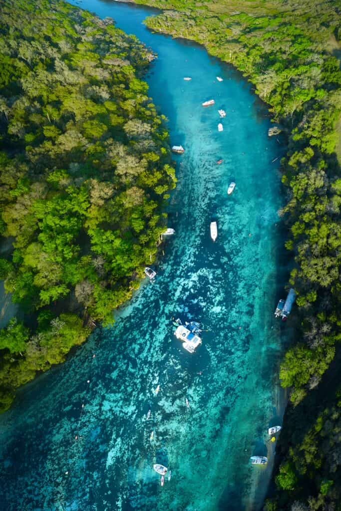 Aerial view looking down at boats in the bright blue water of Emerald Cut.