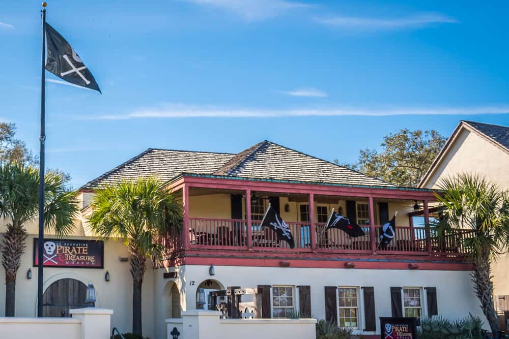 Exterior of the St. Augustine Pirate & Treasure Museum with pirate flags flying.