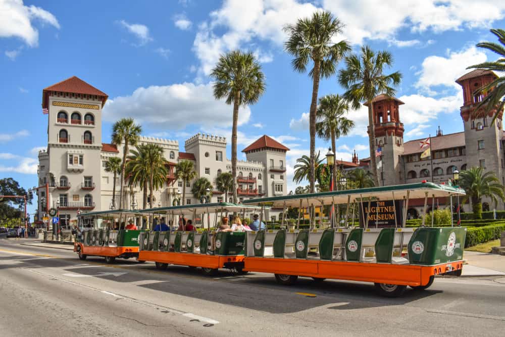A trolley drives by some of the beautiful buildings in St. Augustine.