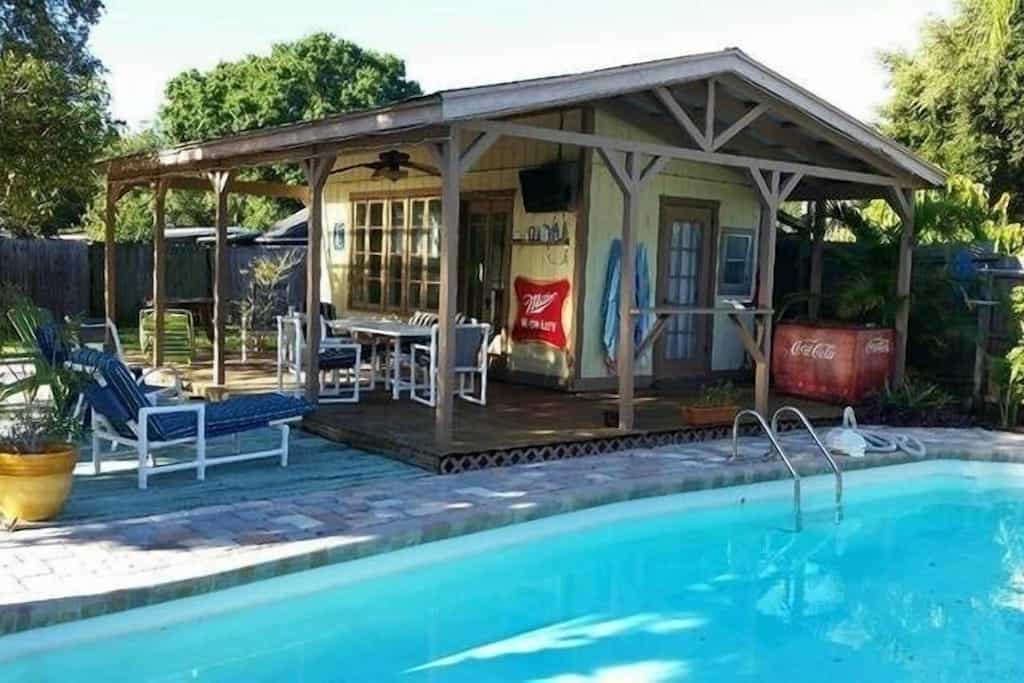 view of the large pool and private cabana of one of the best airbnbs in tampa 