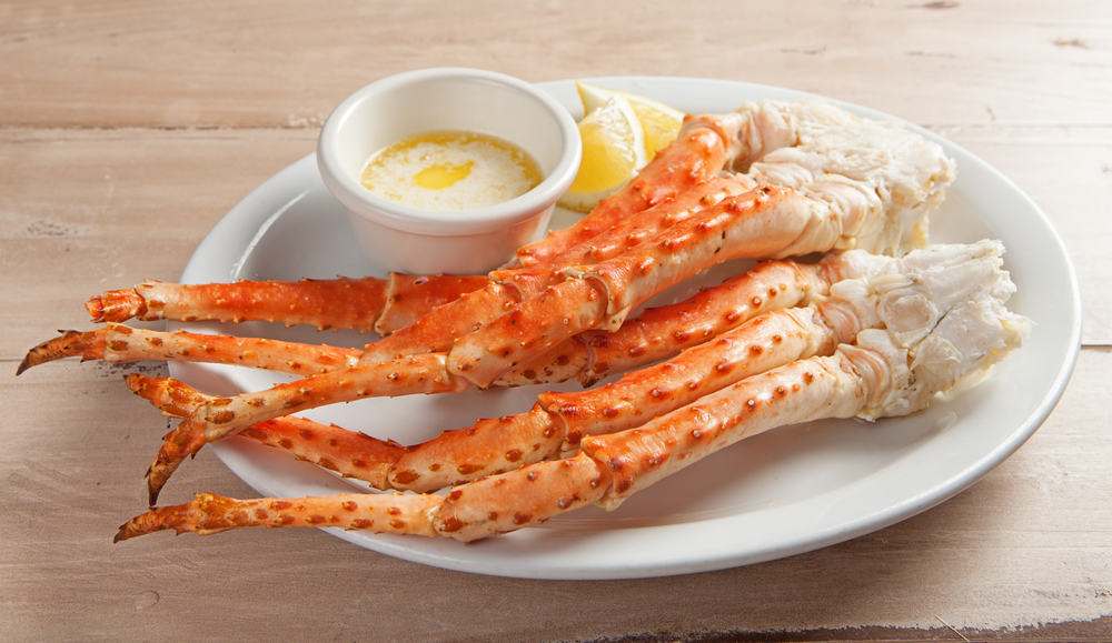 Places like Charlies is one of the best restaurants in Daytona Beach because they offer all you can eat crab legs, as shown in this photo: the legs sit on a plate waiting to be cracked and dipped in the fresh side of melted butter. 