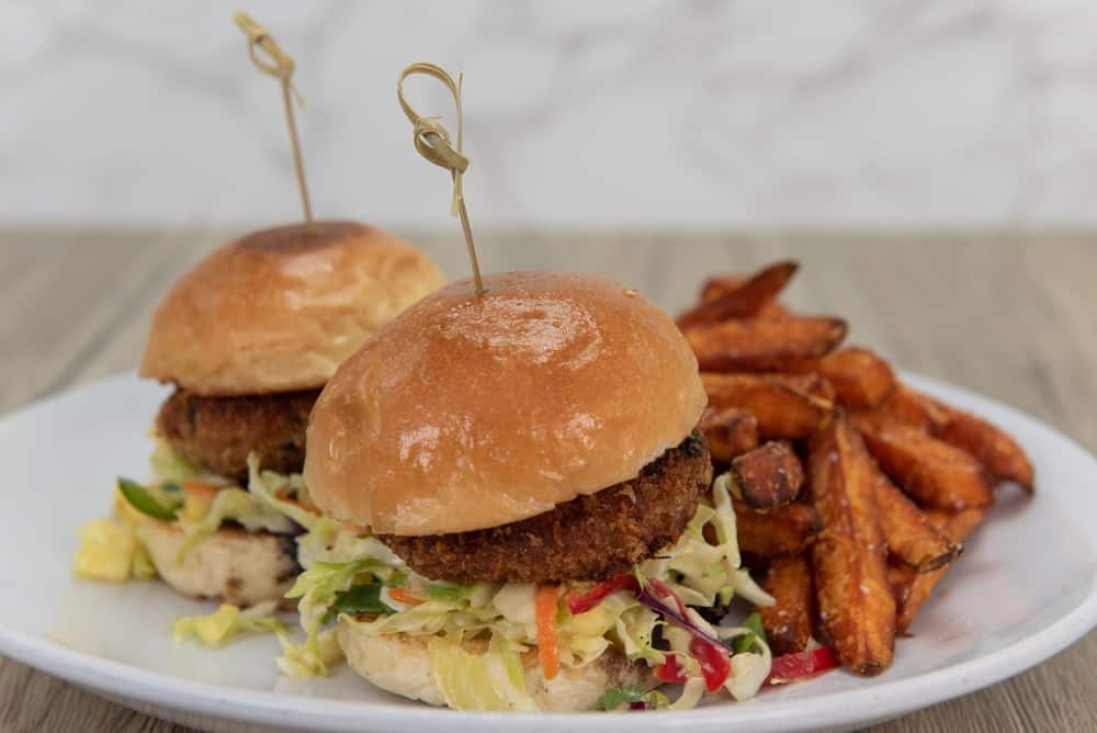 Crab Cake burgers are a must when visiting restaurants in Sanibel: these two mini sliders feature slaw and crab cakes, along with sweet potato fries. 