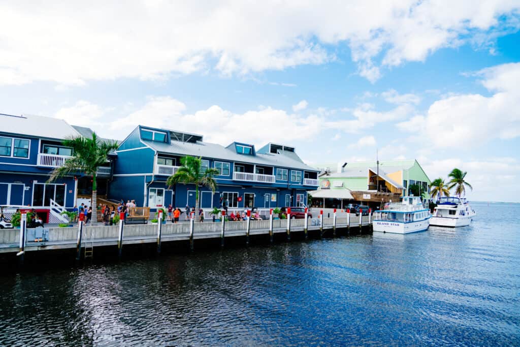 A picture of the waterfront at punta gorda with blue houses and boats tethered nearby