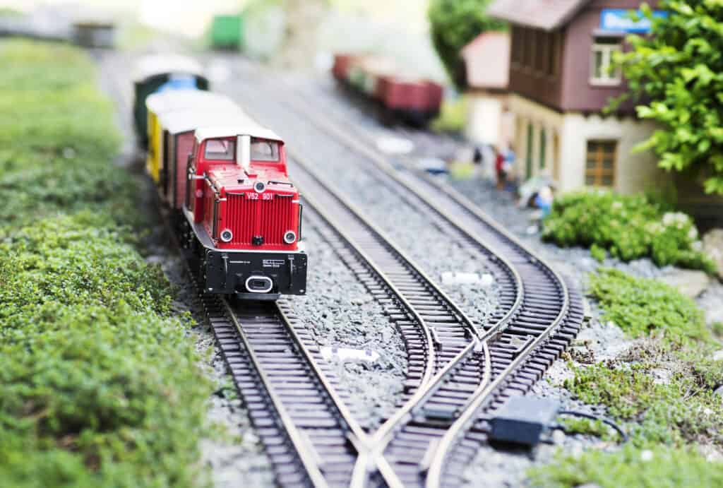 A picture of a red model train on a toy track