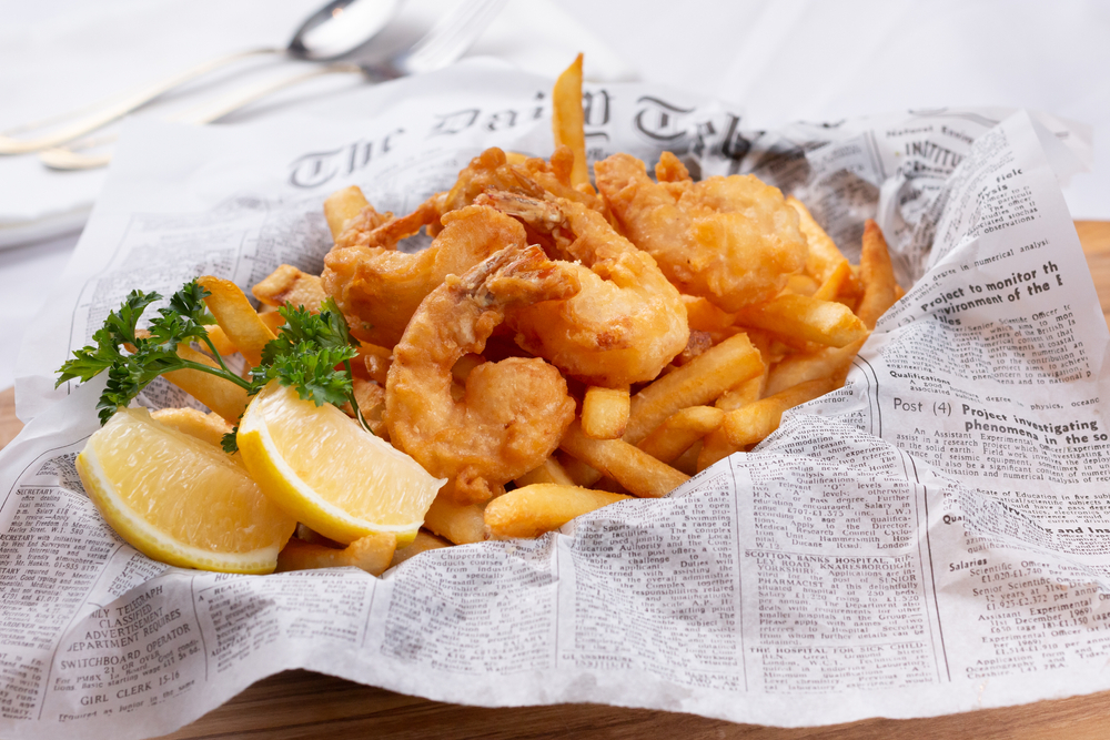 Basket of fried shrimp and French fries.