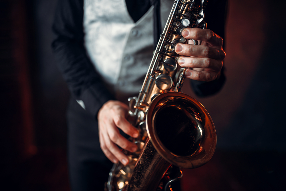 Close up of a man playing a saxophone.