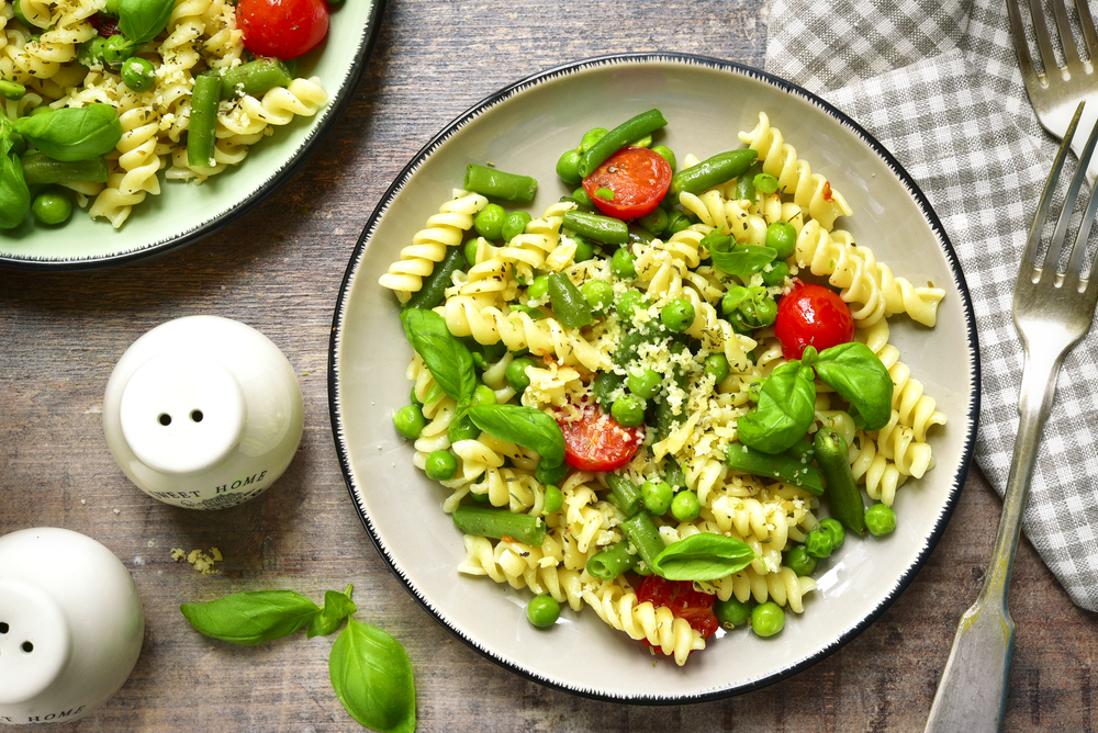 Plate of pasta primavera loaded with vegetables.