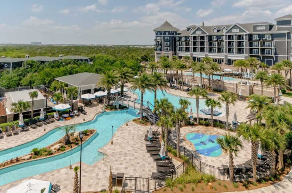 A view of the pool area at henderson beach resort featuring a lazy river and large swimming pool one of the best luxury hotels in Florida