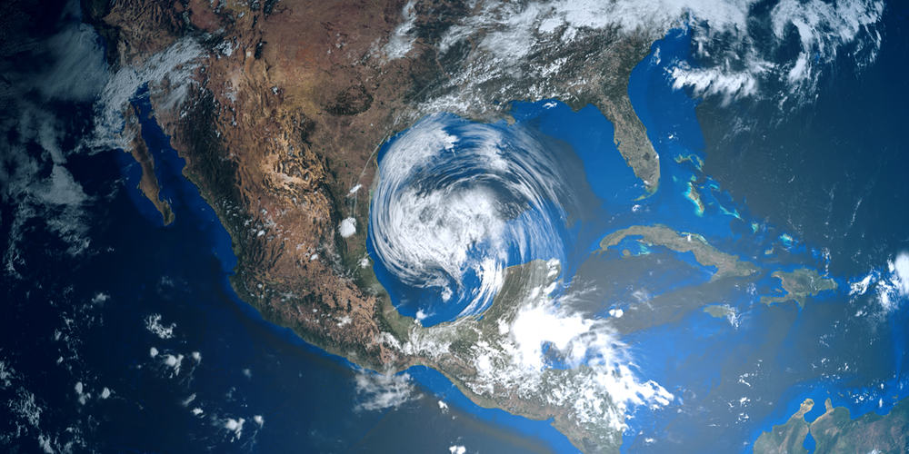 A hurricane swirls in the ocean, about to hit landfall. Storms like these encourage us to have hurricane preparedness lists.