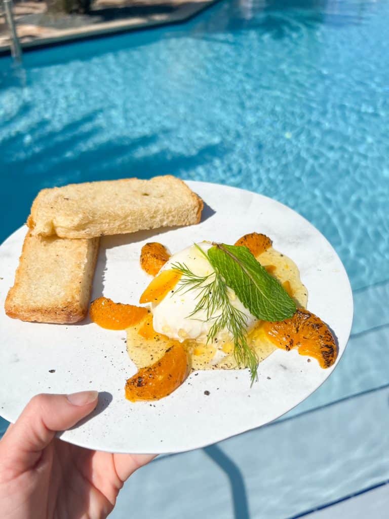 a plate of food at hotel pool