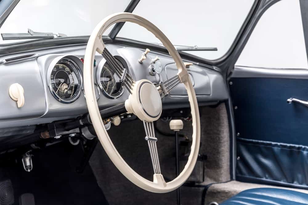 Interior shot of the steering wheel of a vintage Porsche.