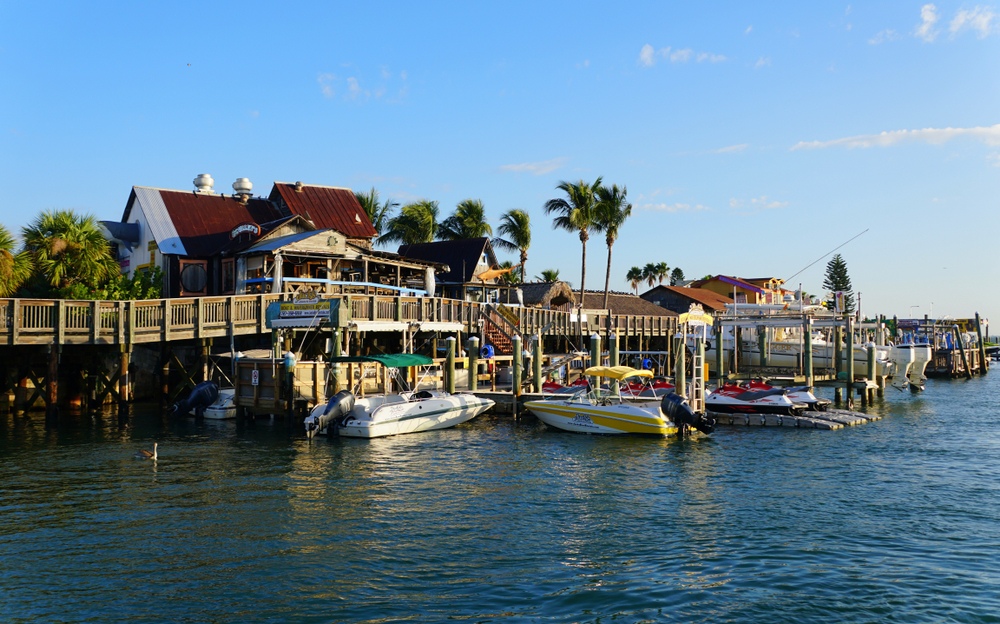 Boats tied up to the wooden boardwalk of John's Pass Village, which is full of the best things to do in Madeira Beach.