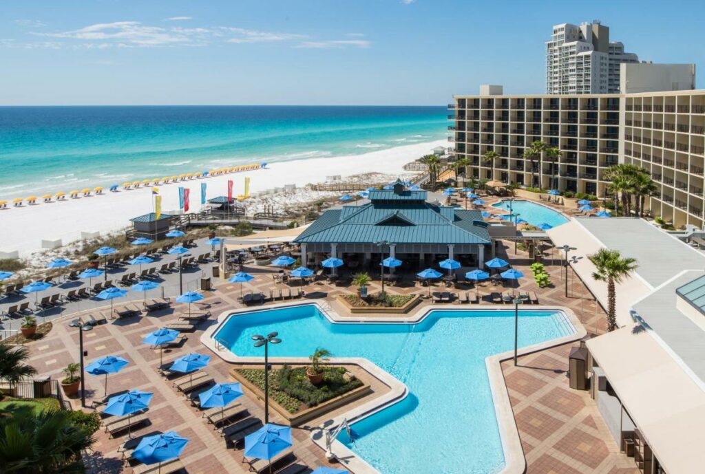 A daytime shot of the pool area by the white sandy beaches of Destin at the Hilton Sandestin Golf Resort