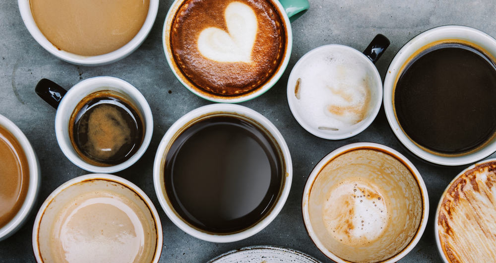 Cups of coffee in all different sized and colored mugs sit on a table. They clump together and are filled with different types of coffee-- like espresso, lattes, and dark roast-- it is the prefect addition for breakfast in Saint Augustine.