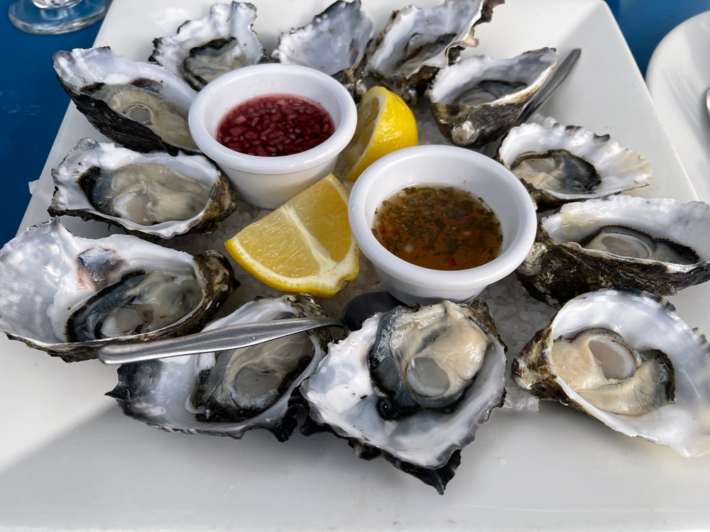 A dozen half-shelled oysters since on a tray of ice with lemon and mignonette sauces, like those served at PJ's Oyster Bar, one of the most popular Indian Rocks Beach restaurants.