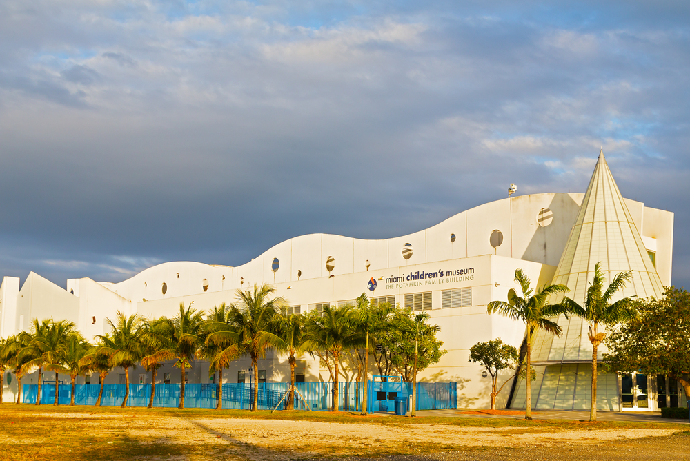 Golden hour over the Miami Children's Museum with palm trees.