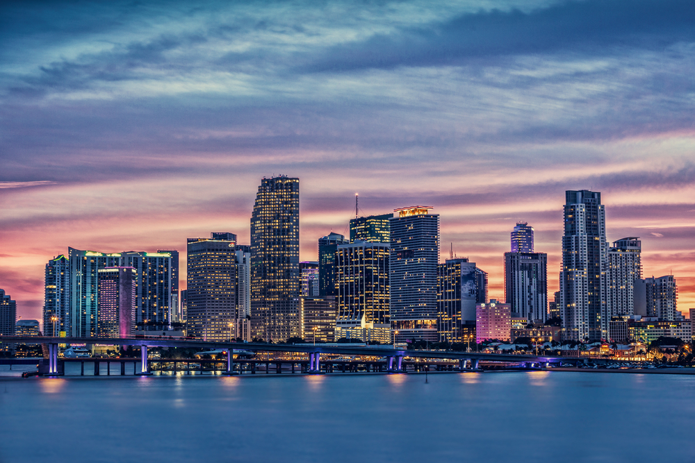 Sunset with blue and purple hues over the skyline of Miami, FL.