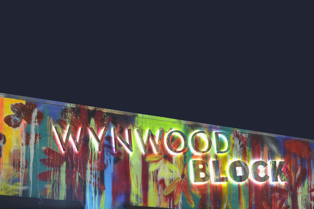 The illuminated sign of Wynwood Walls Block, where seeing the murals is one of the best things to do in Miami at night.