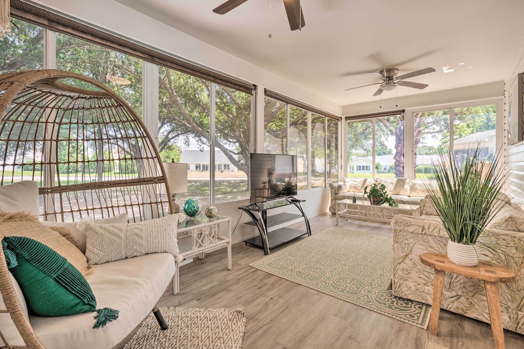 View of an elegant and light filled sunroom at the Lady's Lake VRBO