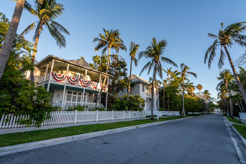 A shot of the Truman House at twilight surrounded by palm trees
