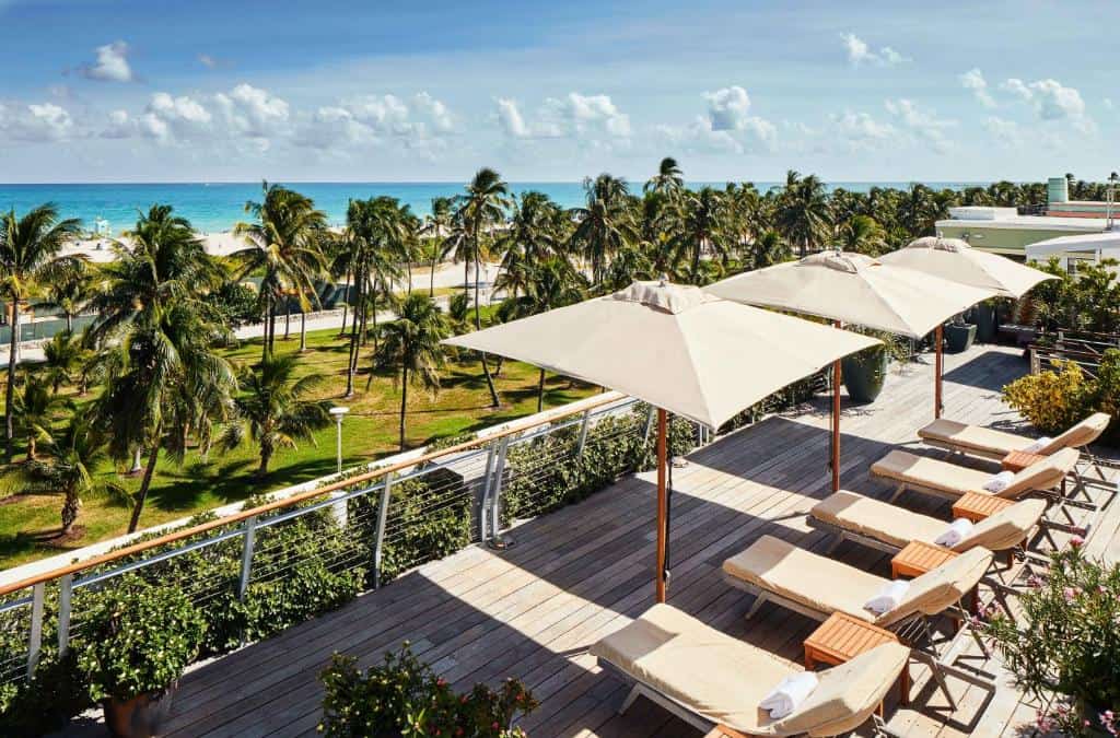 the gorgeous teak deck with chair sand umbrellas overlooking South Beach at where to stay in Miami