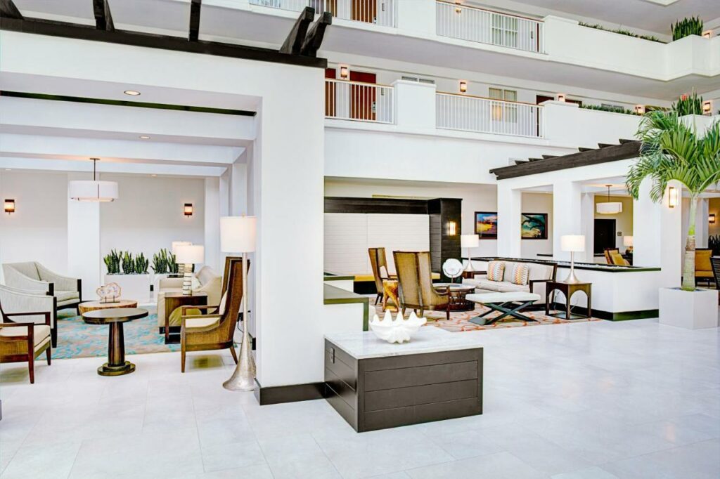 Lobbies can make or break your decisions regarding where to stay in Destin: this lobby is clean with its white colors, seating areas, and accents of brown. 