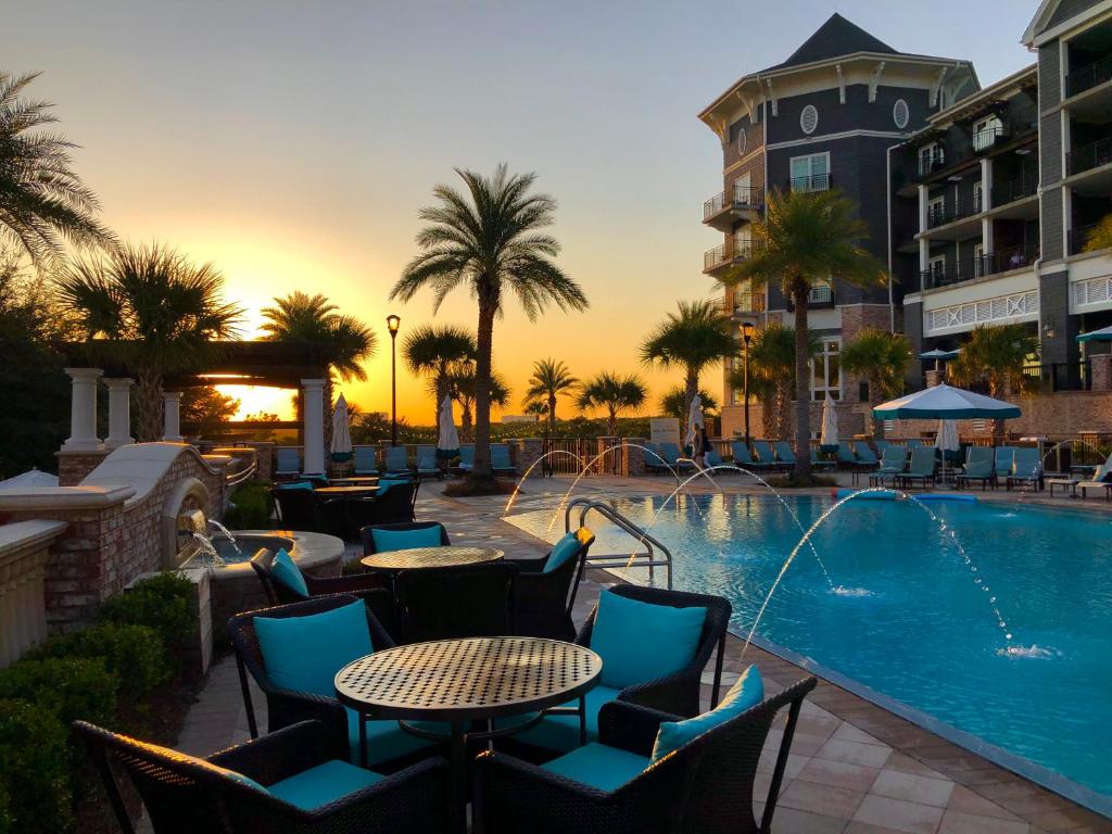 The Henderson Beach Resort is perfect to consider when looking for where to stay in Destin: the huge outdoor pool has big spaces for family, friends, and at sunset it glows, as seen in this photo. 