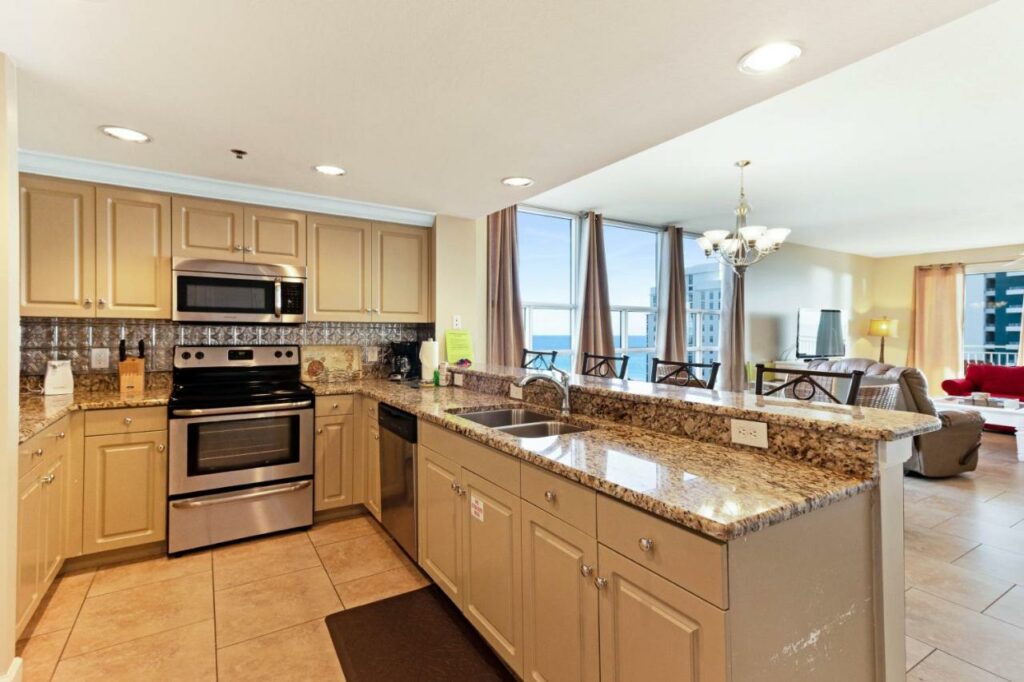 Sterling Shores is a perfect place when looking for where so stay in Destin: this huge kitchen is fully equipped and looks over a balcony that looks over the blue waters below. 