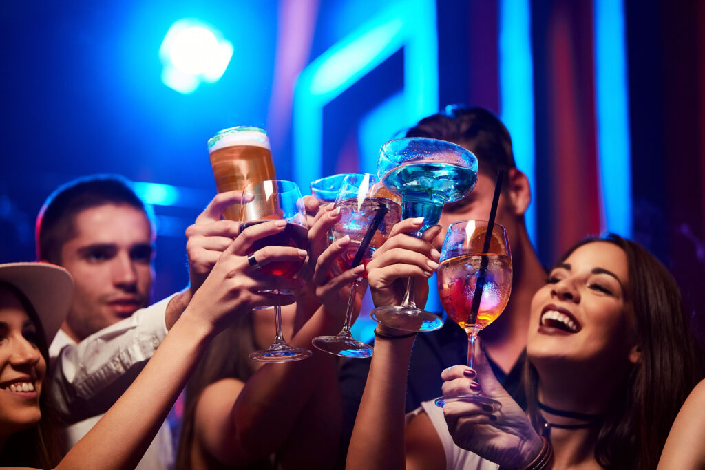 Friends clink drinks together and have a good time at the best Duval Street bars