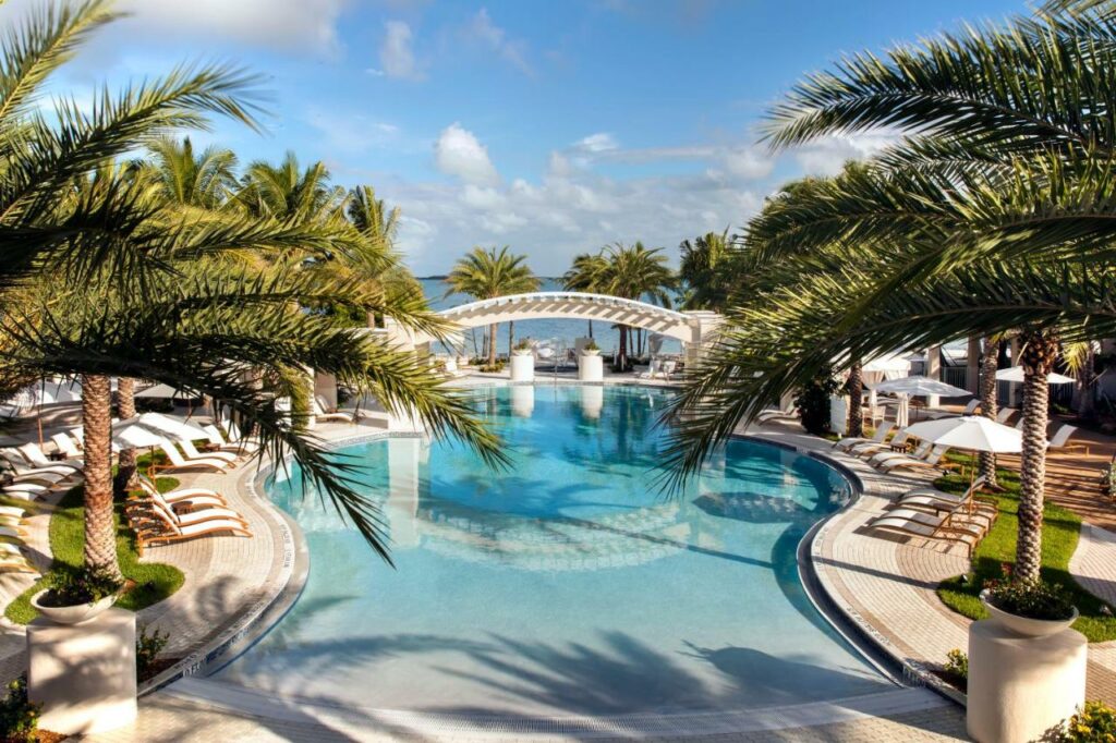 a great pool washed on both sides with white tiling and gorgeous palm trees decorating playa largo's pool!