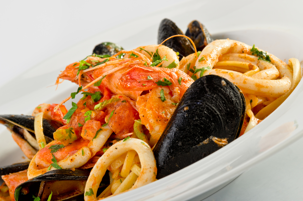 Linguine seafood in a white bowl in an article about the best restaurants in Islamorada. 