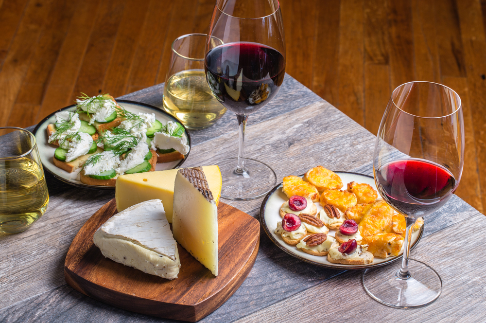 a food and wine pairing with glasses of wine and appetizers and cheeses